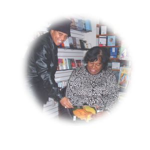 Lynnette C. Velasco  - Author - Zinzi - Signs copy for Loretta Jordan, a happy customer who stopped by to wish C&B Books great success wiith the new store.